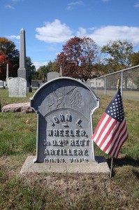Zinc headstone of Civil War Veteran John L. Wheeler. Concrete base (added later) obscures the date of death
